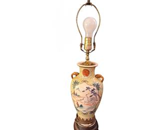 Satsuma-style porcelain vase table lamp featuring a hand-painted landscape with a crane and decorative molded handles set on a crackled yellow background.