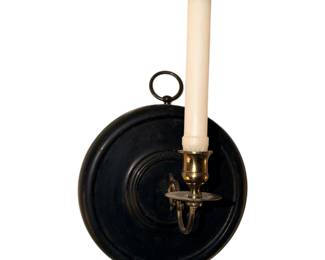 Pair/black round wall sconce with a brass candle holder and a white taper candle.