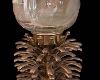 Williamsburg Pineapple Hurricane Candle Holder featuring a brass pineapple-form base and a clear glass hurricane globe
