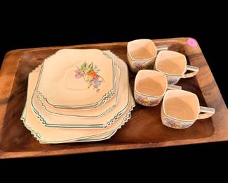 vintage set of square, scalloped ceramic plates and matching teacups in a soft cream or blush color with a floral motif and green trim Crescent China Sienna Ware.