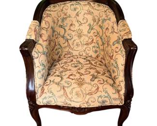 vintage, dark wood-framed armchair with a rounded barrel back and peach-toned floral patterned upholstery./pair