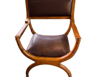 vintage armchair featuring coral and cream vertical stripes and dark, gracefully curved wooden arms.