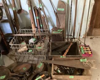 Cast iron skillets including Wagner, antique hand saw, metal milk crates, Vintage pool balls (missing the cue ball) vintage sleds and loads of other barn finds that would be perfect in modern farmhouse decor