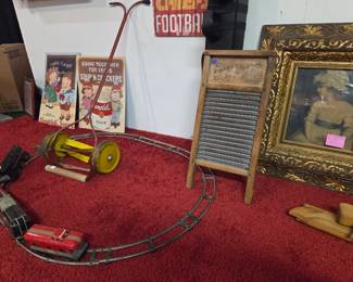 Toy lawn mower, toy train (key that makes it run missing, antique washbasin. Campbell Kids metal signs, Sir Joshua Reynolds print on antique ornate frame