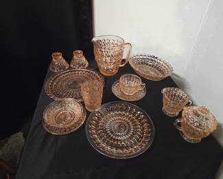 8 piece plate setting, plus pitcher, sugar and creamer. Serving does, players and candle sticks. (Pink Buttons and Bows depression glass). Very rare to find complete settings and extras