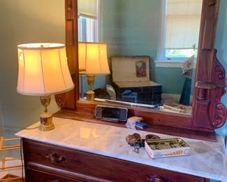 third of three marble top dressers