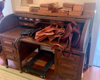vintage roll top desk with cigar boxes and artist made leather crafts