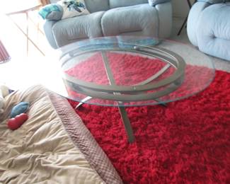 red rug and glass top w/ metal leg coffee table