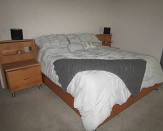 another view of the clean & unique bed with night stands