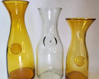 FHM082 - Three Vintage Glass Wine Carafes / Paul Masson Since 1852 & Amber Embossed Seal Decanters
