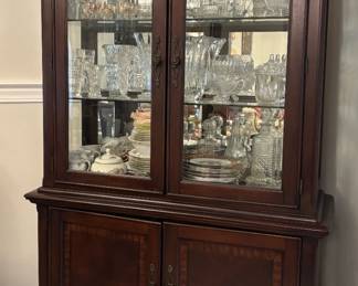 Dark wood china cabinet with glass doors on top
