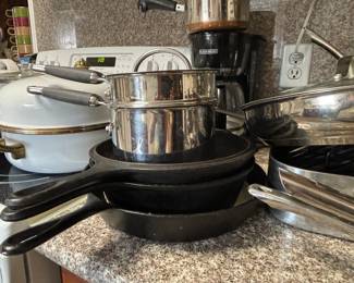 Well-seasoned cast iron skillets and sauce pans with lids