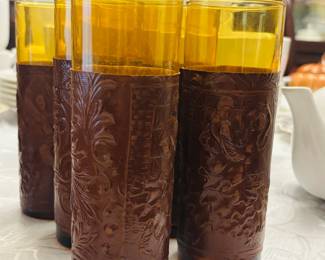 Mid-century amber glassware set with embossed leather sleeves