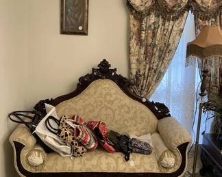 Victorian-style carved wood loveseat
