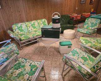 Vintage metal outdoor furniture set: glider sofa, lounge chair, 4 folding chairs, & coffee table.  Also pictured: vintage Coleman cooler set 