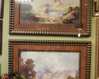 Framed reproductions of Thomas Moran's landscape paintings.