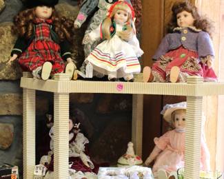 Porcelan dolls, Indiana green glass cradle, and baby silver gift