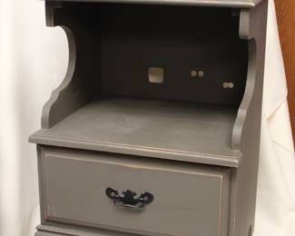Gray-painted wooden nightstand, with an open upper shelf and single lower drawer