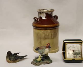 Two hand carved ducks with a portable clock and jug.