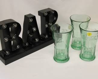 Bar sign with vintage coca-cola glasses