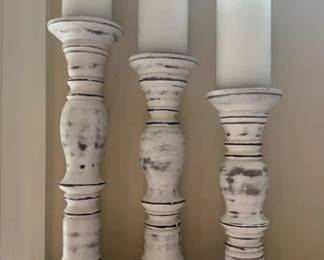 Set of wooden candlesticks, one of several in auction
