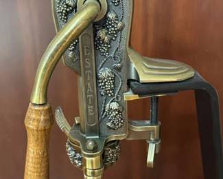 Detail on vintage Rogar Estate brass and cast metal wine bottle opener