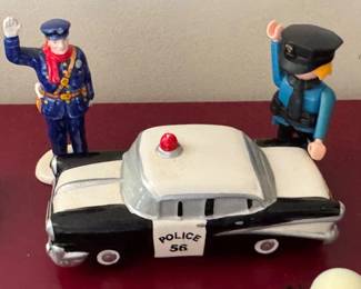 Collection of vintage toy police cars and police action figures