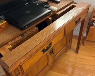Cabinet Opens into a table. Has 4-5 leaf inserts.