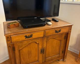 Cabinet Opens into a table. Has 4-5 leaf inserts.