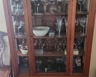 oak mission style display case with glassware