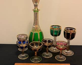 O6 - $1250. Antique Bohemian or Moser-style cut-to-clear glass decanter and cordial set with ornate gold gilding. 2 Tall Wine Glasses. 5 Champagne Coupe. Decanter & Stopper. One glass has a *tiny* chip in the base. All other pieces are in excellent condition!