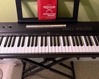 O26 - $40. BCP Digital Piano. Measures 51” W x 14” D x 32” Tall.