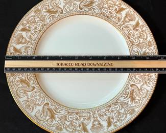 O129 - $400. Set of Wedgwood Gold "Florentine" China. 12 - 10.75" Plates, 11 - 8.25" Salad Plates, 2 - 8" Soup Bowls, 9 - 6" Bread Desert Plates, 7 - 6" Saucers, 9 - Tea Cups, 1 - 17.5" x 13.5" Oval Serving Platter.