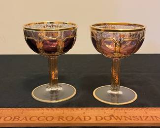 O6 - $1250. Antique Bohemian or Moser-style cut-to-clear glass decanter and cordial set with ornate gold gilding. 2 Tall Wine Glasses. 5 Champagne Coupe. Decanter & Stopper. One glass has a *tiny* chip in the base. All other pieces are in excellent condition!