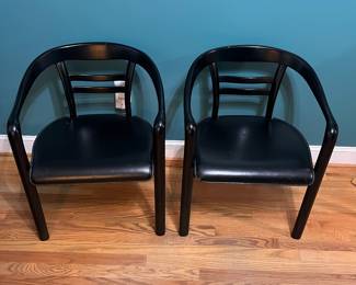 O123 - $75. Pair of Black chairs. Leather Seats. Each Measures 22.5" W x 19" D x floor to seat 17" x floor to back 28" Tall. Both show signs of wear and one seat is damaged on a corner.