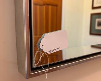 O35 - $30. Chrome Framed Mirror. Measures 25.25” W x 37” Tall.