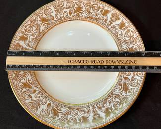 O129 - $400. Set of Wedgwood Gold "Florentine" China. 12 - 10.75" Plates, 11 - 8.25" Salad Plates, 2 - 8" Soup Bowls, 9 - 6" Bread Desert Plates, 7 - 6" Saucers, 9 - Tea Cups, 1 - 17.5" x 13.5" Oval Serving Platter.