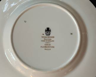O129 - $400. Set of Wedgwood Gold "Florentine" China. 12 - 10.75" Plates, 11 - 8.25" Salad Plates, 2 - 8" Soup Bowls, 9 - 6" Bread Desert Plates, 7 - 6" Saucers, 9 - Tea Cups, 1 - 17.5" x 13.5" Oval Serving Platter.