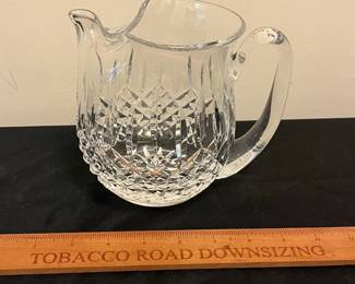 O95 - $30. Waterford Crystal “Lismore” Pitcher with Ice Lip. Measures 6” Tall.