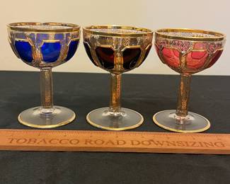 O6 - $1250. Antique Bohemian or Moser-style cut-to-clear glass decanter and cordial set with ornate gold gilding. 2 Tall Wine Glasses. 5 Champagne Coupe. Decanter & Stopper. One glass has a *tiny* chip in the base. All other pieces are in excellent condition!
