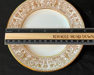 O129 - $400. Set of Wedgwood Gold "Florentine" China. 12 - 10.75" Plates, 11 - 8.25" Salad Plates, 2 - 8" Soup Bowls, 9 - 6" Bread Desert Plates, 7 - 6" Saucers, 9 - Tea Cups, 1 - 17.5" x 13.5" Oval Serving Platter.