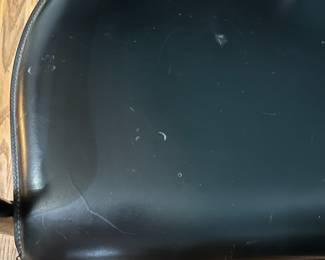 O123 - $75. Pair of Black chairs. Leather Seats. Each Measures 22.5" W x 19" D x floor to seat 17" x floor to back 28" Tall. Both show signs of wear and one seat is damaged on a corner.
