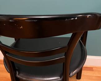 O123 - $75. Pair of Black chairs. Leather Seats. Each Measures 22.5" W x 19" D x floor to seat 17" x floor to back 28" Tall. Both show signs of wear and one seat is damaged on a corner.