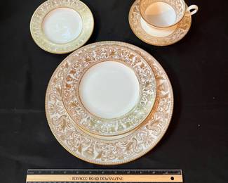 O129 - $400. Set of Wedgwood Gold "Florentine" China. 12 - 10.75" Plates, 11 - 8.25" Salad Plates, 2 - 8" Soup Bowls, 9 - 6" Bread Desert Plates, 7 - 6" Saucers, 9 - Tea Cups, 1 - 17.5" x 13.5" Oval Serving Platter.