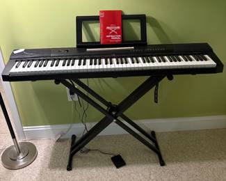 O26 - $40. BCP Digital Piano. Measures 51” W x 14” D x 32” Tall.