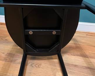 O123 - $75. Pair of Black chairs. Leather Seats. Each Measures 22.5" W x 19" D x floor to seat 17" x floor to back 28" Tall. Both show signs of wear and one seat is damaged on a corner.