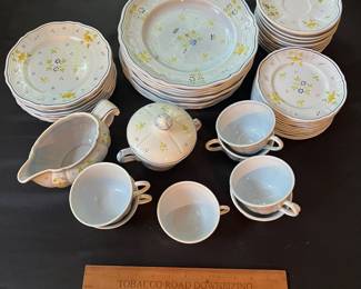 O109 - $275. Set of Longchamp "Printemps" Pottery. 9 - 10" Dinner Plates, 9 - 7.5" Salad Plates, 11 - 6.75" Desert Plates, 11 - 6.25" Saucers, 7 - Tea Cups, 1 Gravy Boat, 1 Sugar Dish.