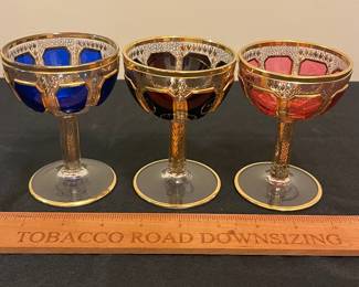 O6 - $1250. Antique Bohemian or Moser-style cut-to-clear glass decanter and cordial set with ornate gold gilding. 2 Tall Wine Glasses. 5 Champagne Coupe. Decanter & Stopper. One glass has a *tiny* chip in the base. All other pieces are in excellent condition!
