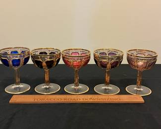 O6 - $1250. Antique Bohemian or Moser-style cut-to-clear glass decanter and cordial set with ornate gold gilding. 2 Tall Wine Glasses. 5 Champagne Coupe. Decanter & Stopper. One glass has a *tiny* chip in the base. All other pieces are in excellent condition!