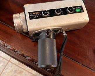 Yashica Electro LD-6 Super 8 Movie Camera – Vintage Yashica Electro LD-6 Super 8 movie camera featuring a built-in zoom lens, pistol-grip handle, and manual exposure controls. A wonderful collectible for photography enthusiasts, vintage camera collectors, or retro décor. Untested; sold as found.